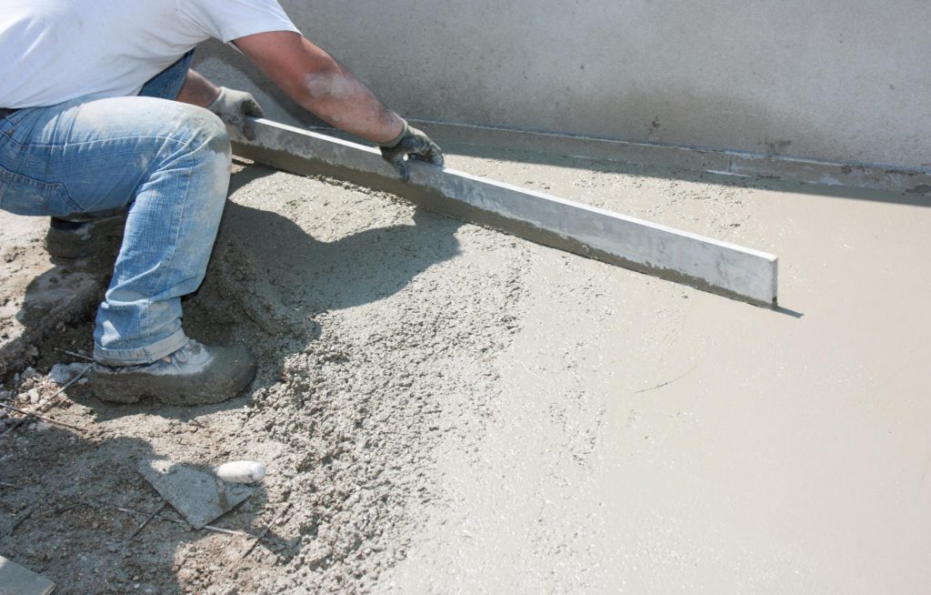 man guiding to level the cement